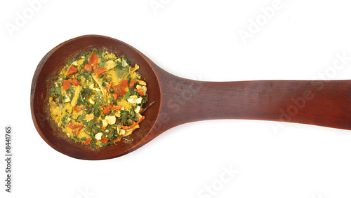 Vegetables and spices dried condiment in wooden spoon