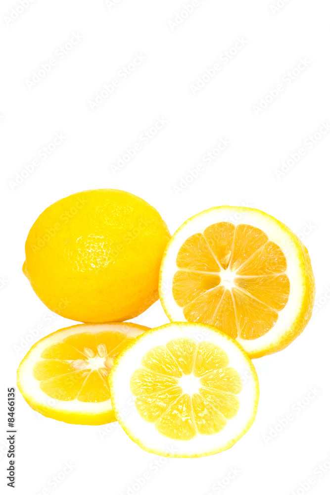 Whole and Sliced Bright Yellow Meyer Lemons On White Background