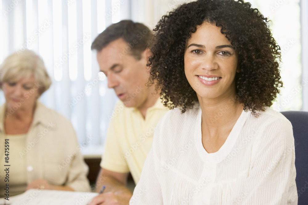 Mid adult woman studying with other adult students