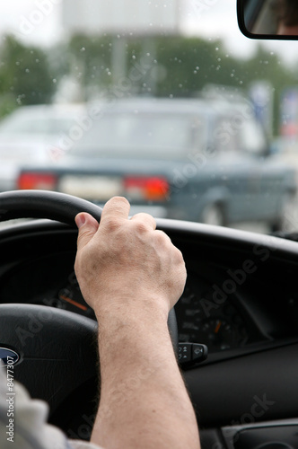 Wallpaper Mural man holds a steering wheel of the car Torontodigital.ca