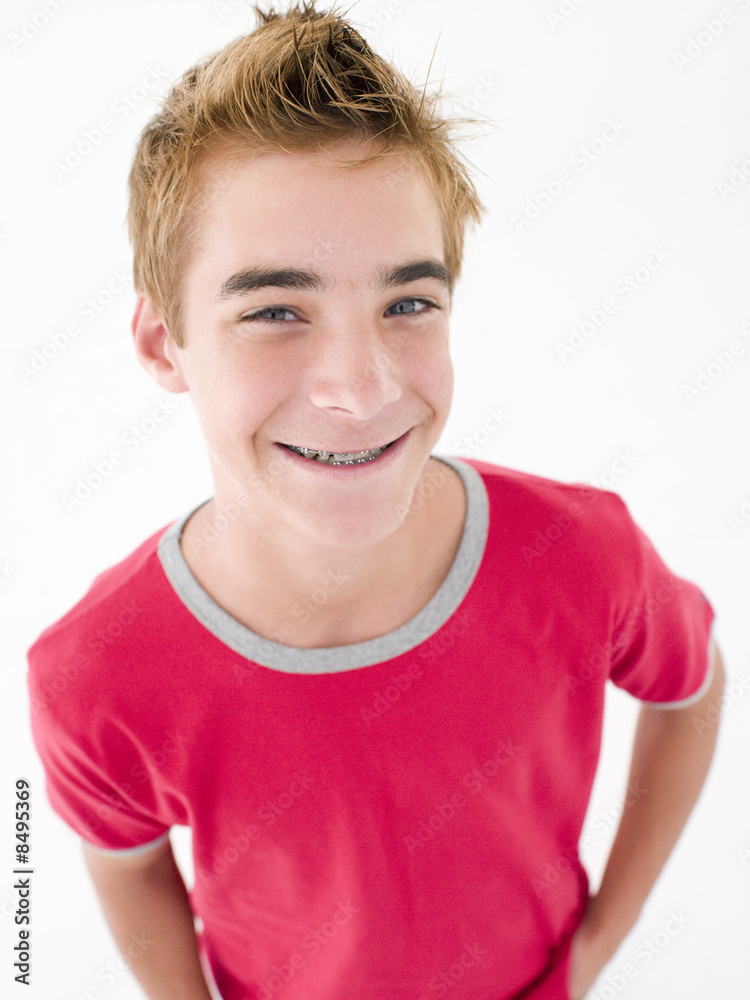 Teenage boy with hands in pockets smiling Teenage boy with hands in pockets smiling