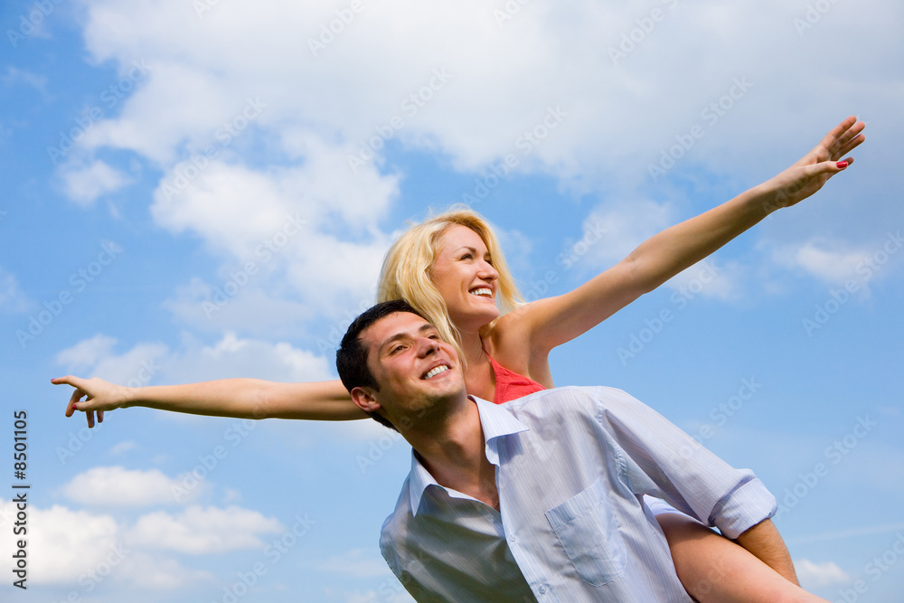 Young love Couple smiling under blue sky