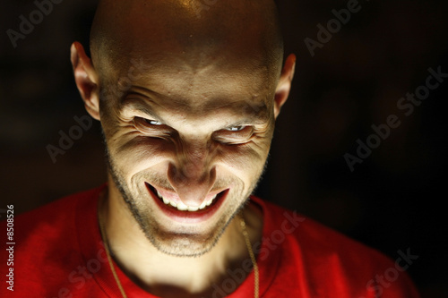Photos terrifying man with a grin smile looking at the camera