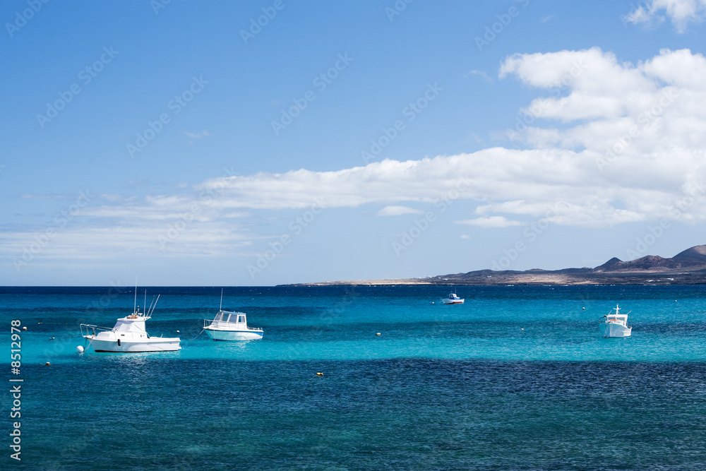 small white fisher boats at Lanzarote coast