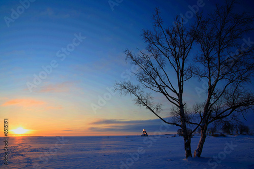 Sunset on frozen sea shore