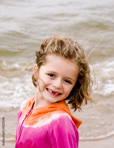 Little Girl playing at the beach in the summer time