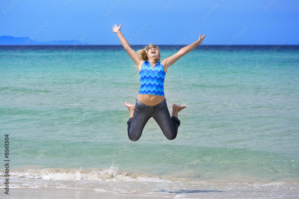 Woman jumping on the beach