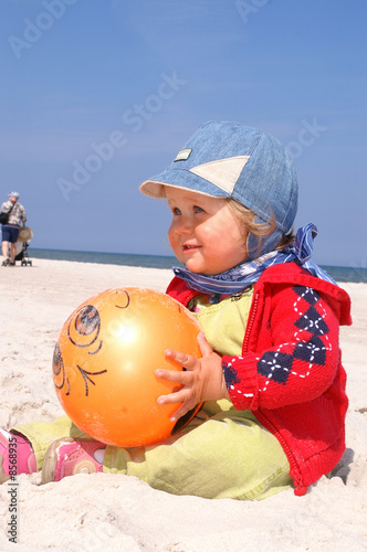 Baby and orange ball