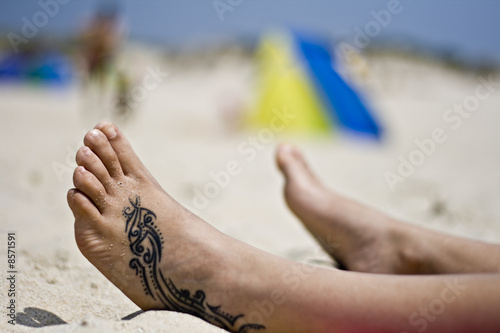 Tattoo foot in the sand