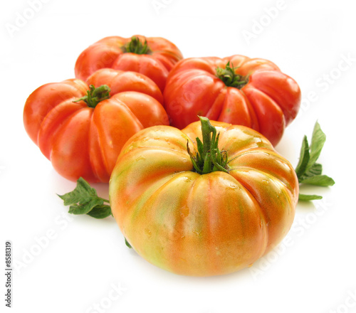 Tomatoes orange and red with leaves