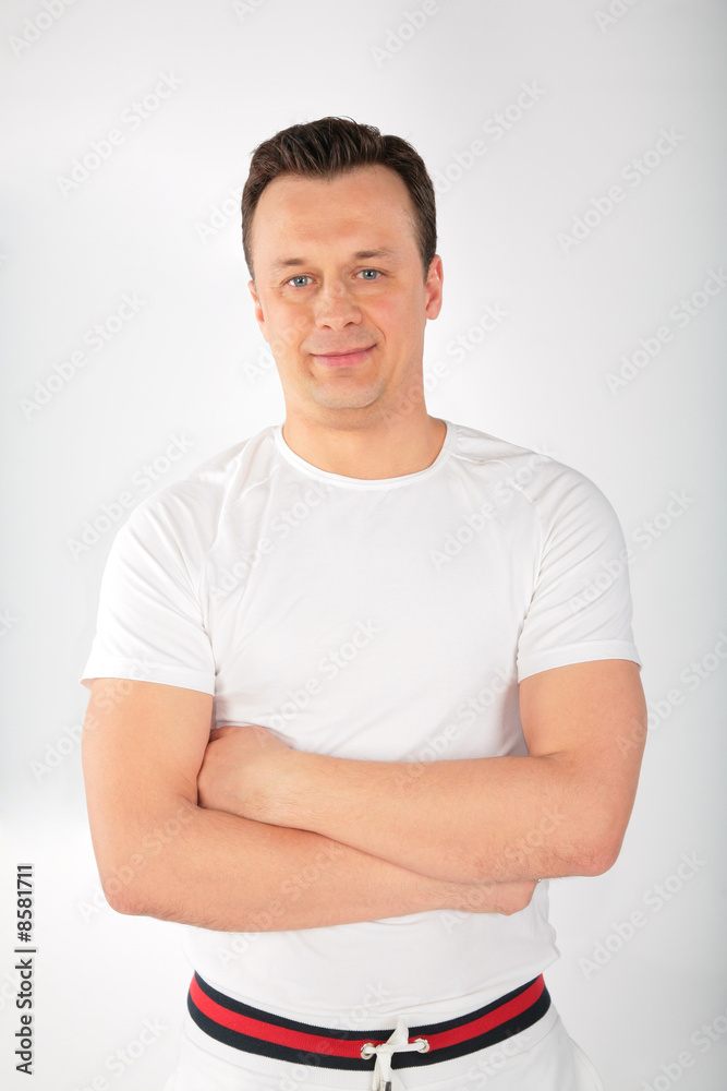man in white singlet with crossed hands man in white singlet with crossed hands