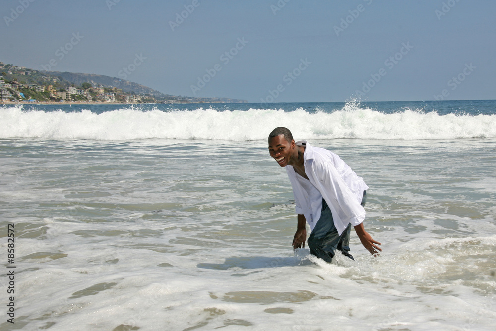 African American Man Running and Playing in the Surf African American Man Running and Playing in the Surf