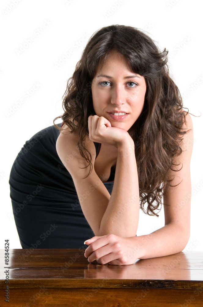 Young secretary supported on the desk with seductive expression Young secretary supported on the desk with seductive expression
