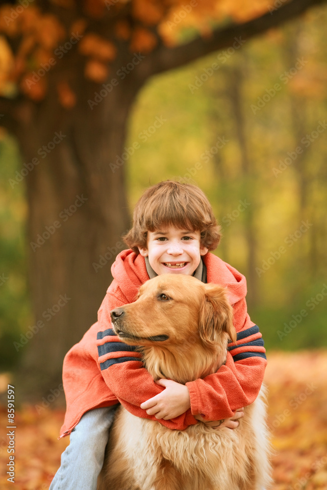 Boy Hugging Dog in the Fall