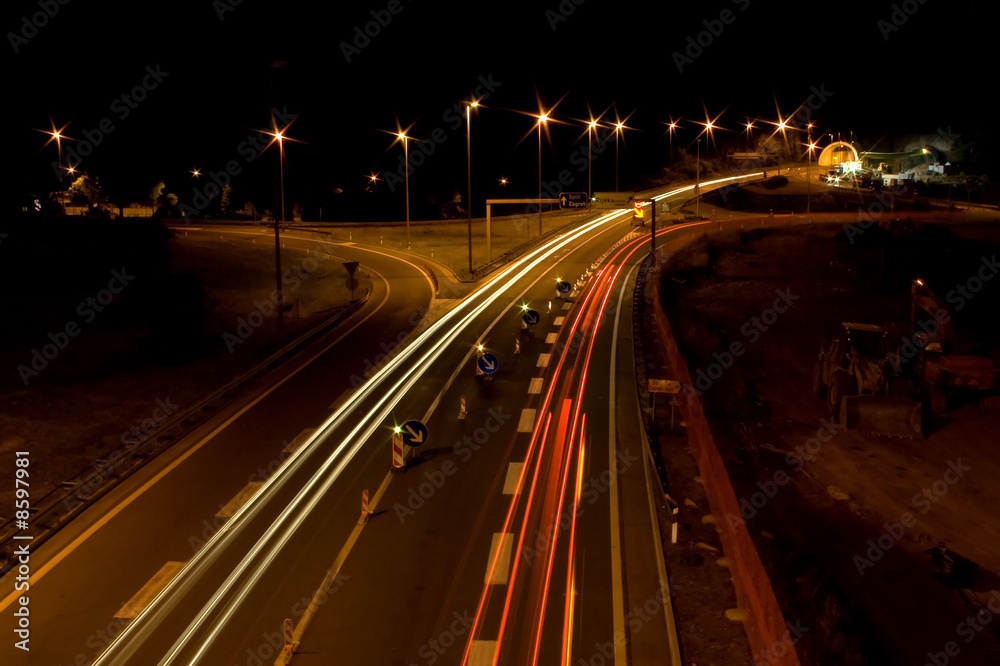 Straight night highway with car's traces