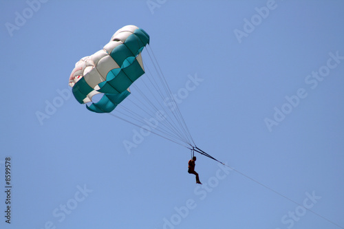 Flying parachute on background with blue sky
