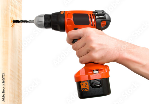 Man's hand holding drill