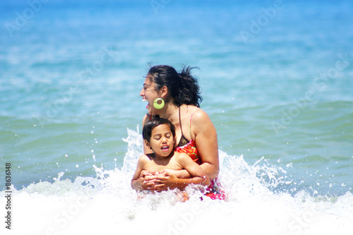 Mother Having Fun with Son in the Water at the Beach © Monart Design