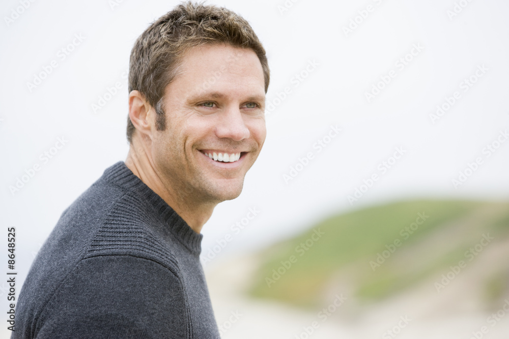Man standing at beach smiling Man standing at beach smiling
