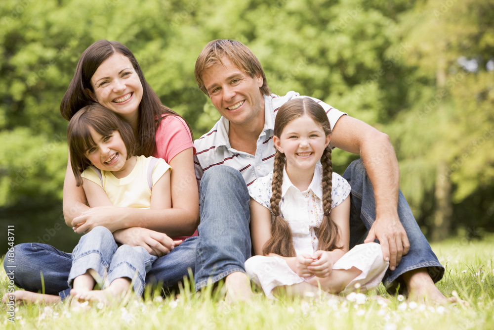 Family outdoors smiling