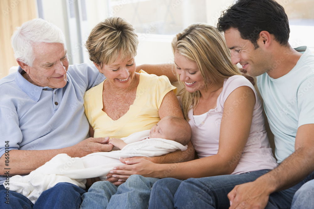 Family in living room with baby smiling Family in living room with baby smiling