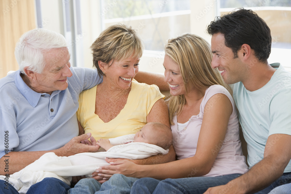 Family in living room with baby smiling Family in living room with baby smiling