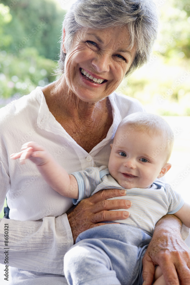Grandmother outdoors on patio with baby smiling Grandmother outdoors on patio with baby smiling