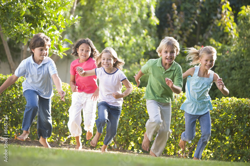 Five young friends running outdoors smiling #8651734