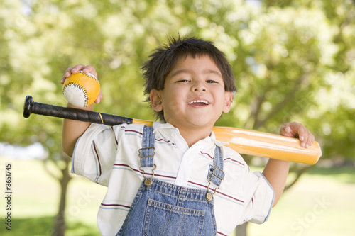 Photography Young boy holding baseball bat outdoors smiling