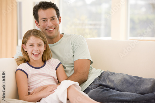 Man and young girl in living room smiling