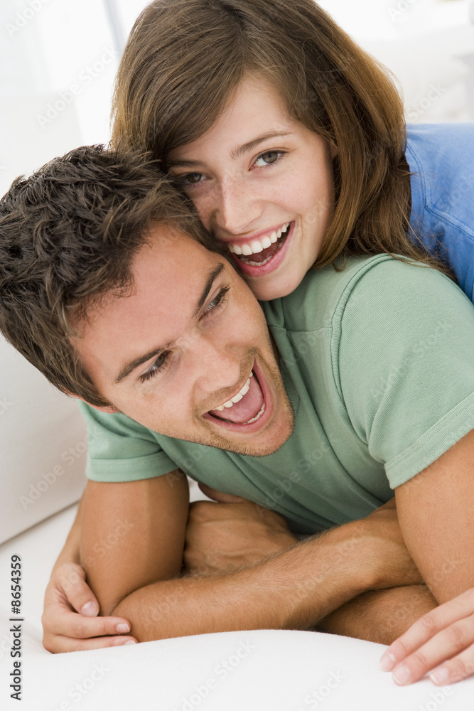 Couple in living room smiling Couple in living room smiling