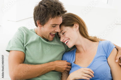 Couple in living room smiling © Monkey Business