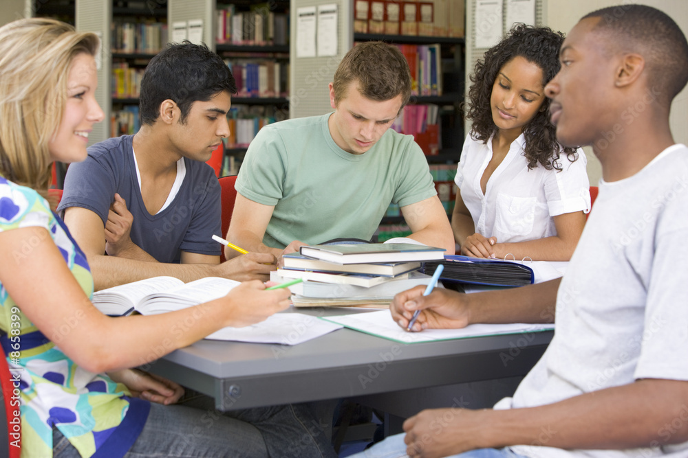 College students studying together in a library College students studying together in a library