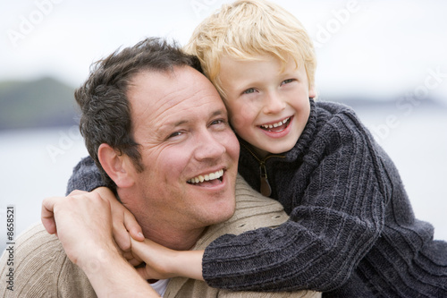 Father and son at beach smiling