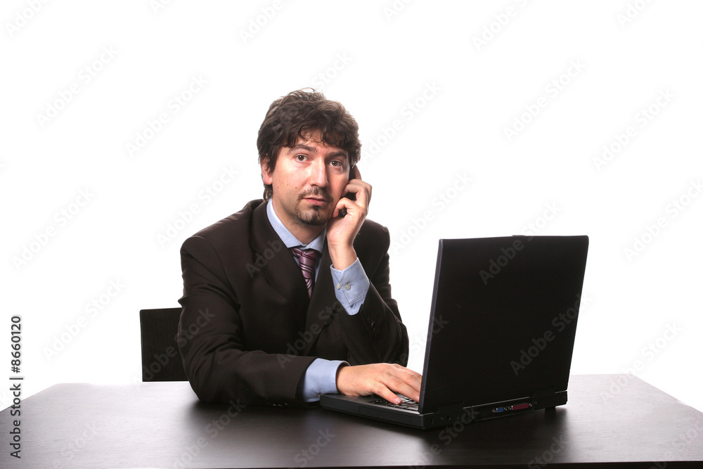 young business man working with his laptop and talking on his ce young business man working with his laptop and talking on his ce