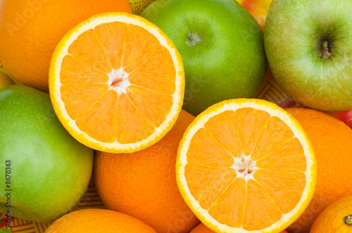 Close up of half cut oranges and apples