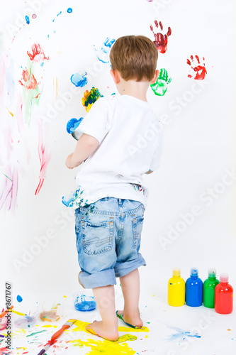 Child painting on the wall