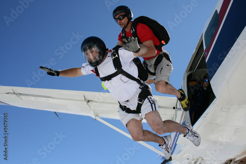 Two Skydivers exit an airplane