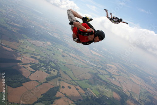 Skydiver flies past cameraman