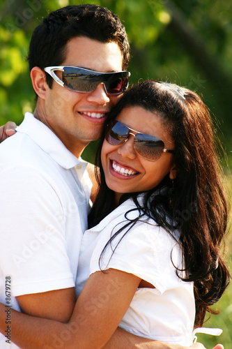 Happy Couple Smiling & Wearing Sunglasses in the Summer © Monart Design