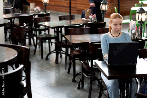 girl with computer in cafe