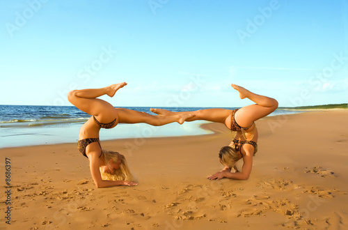 Photography Two acrobatic girl on the beach