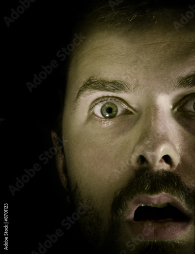 Closeup on amazed scared male face