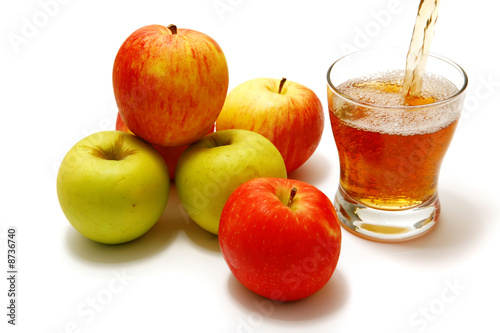 apples over white with filled glass