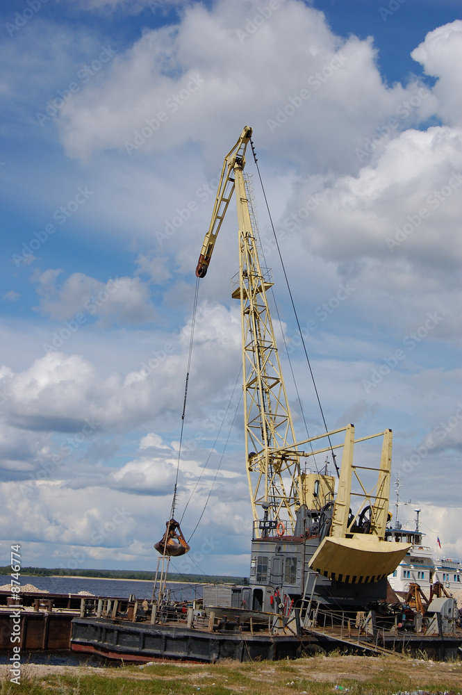 The port dredge unloads sand from the barge The port dredge unloads sand from the barge