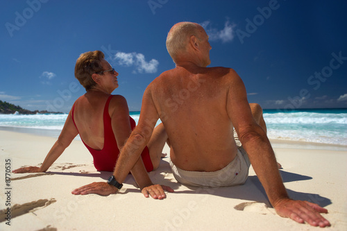 elderly couple on beach series - sunbathing