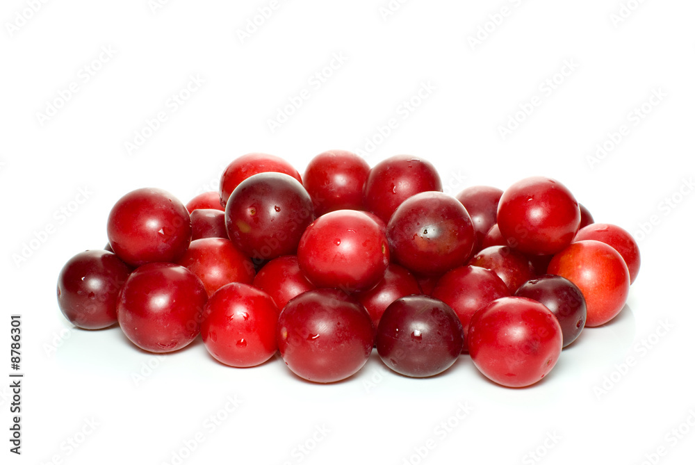 Pile of red cherry plums isolated on the white background Pile of red cherry plums isolated on the white background