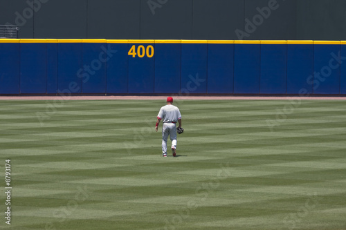 Baseball player walking to outfield