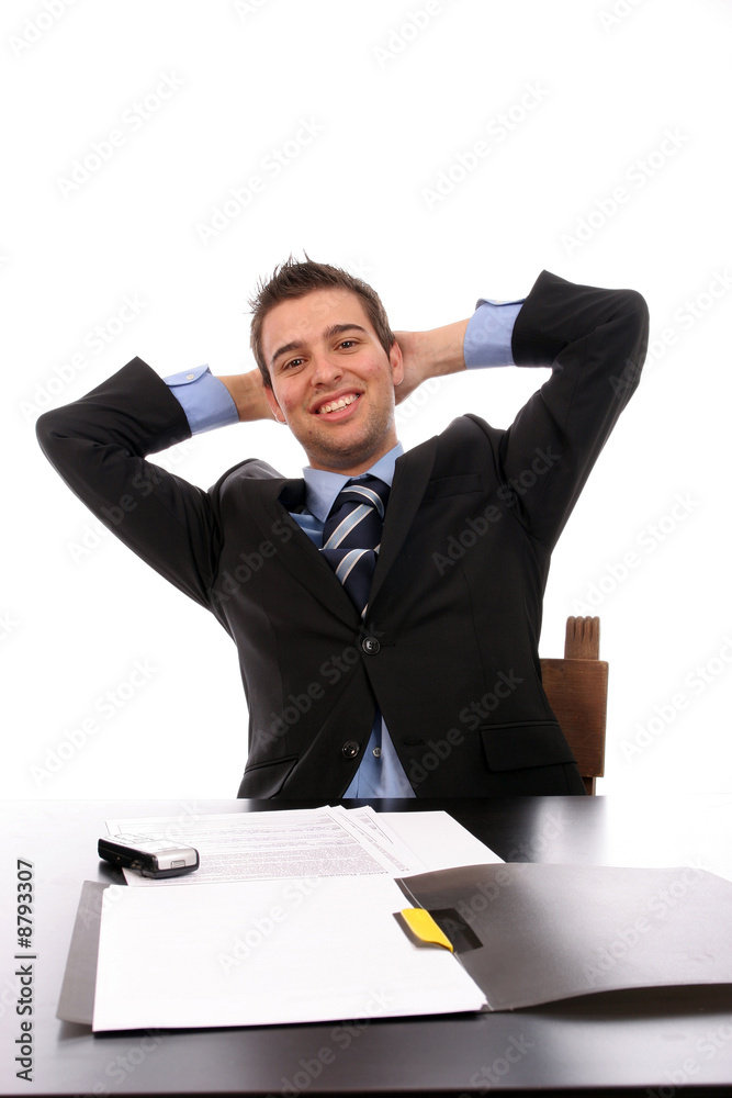Successful businessman relaxing over his desk, isolated Successful businessman relaxing over his desk, isolated