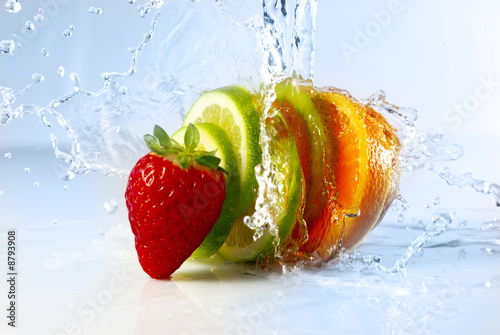 water splashing over sliced fruits